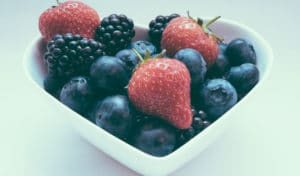 A heart-shaped bowl golds a medley of strawberries, blackberries, and blueberries | Nutrition Blog | Blood Pressure Awareness