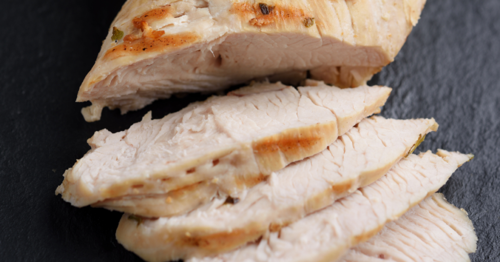 Cooked and seasoned white turkey sliced into thick slices