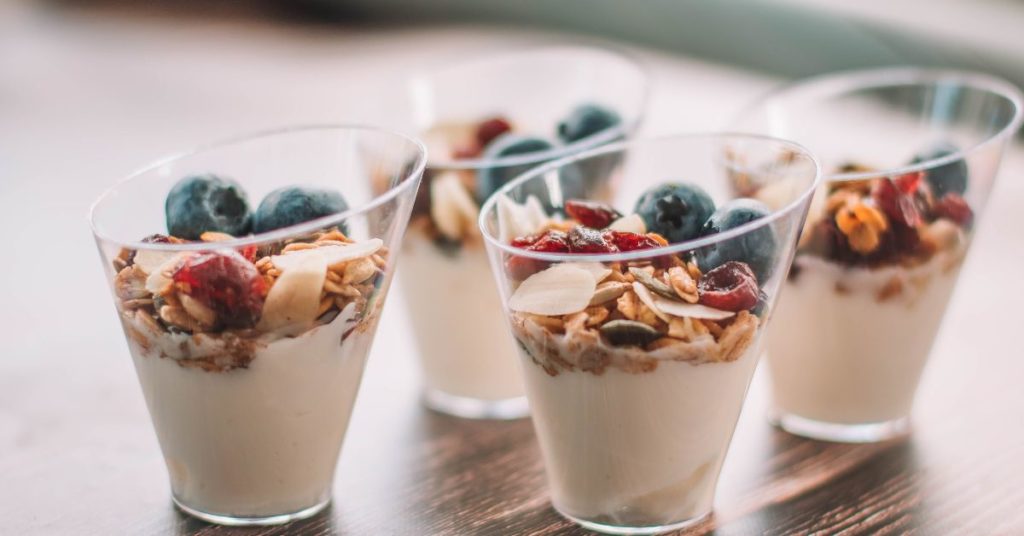 Healthy snack ideas like blueberries and granola atop yogurt
