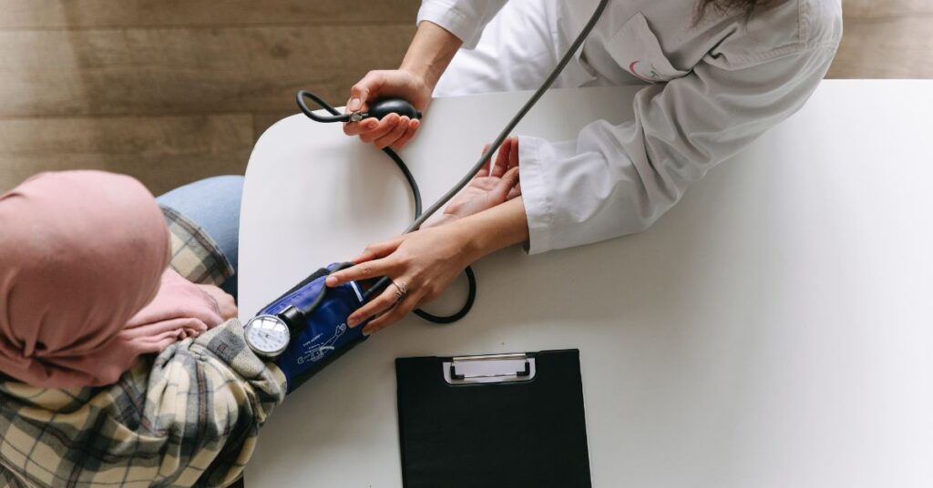 Woman gets her blood pressure taken by a doctor