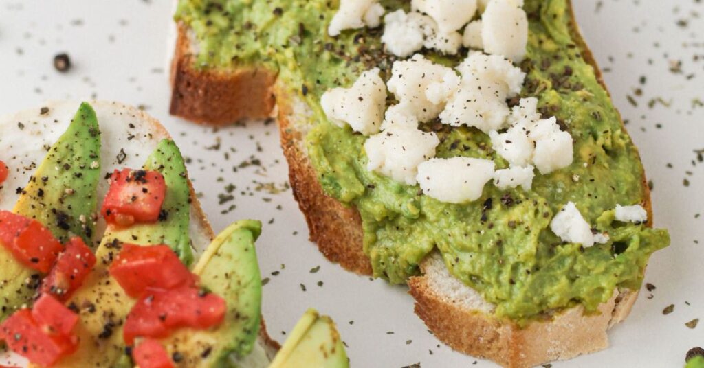 Slices of avocado toast topped with other healthy fats, like seeds and cheeses