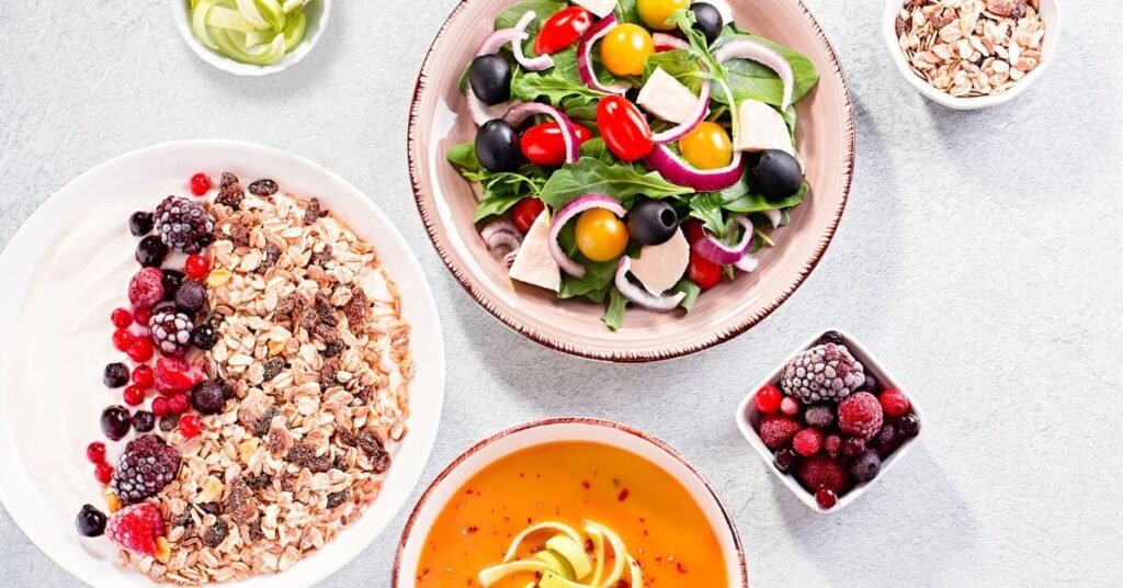 Various plates of healthy looking food, like salads, oats, soups and berries, long term weight loss management