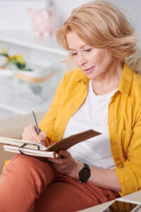 woman writing in a food journal