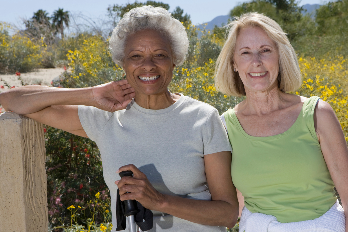 2 women taking a break from a walk - healthy physical activity for weight loss