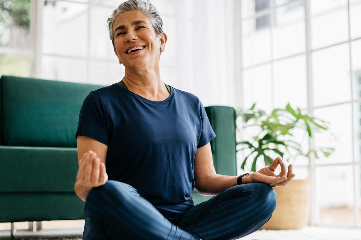 woman smiling after yoga practice in living room