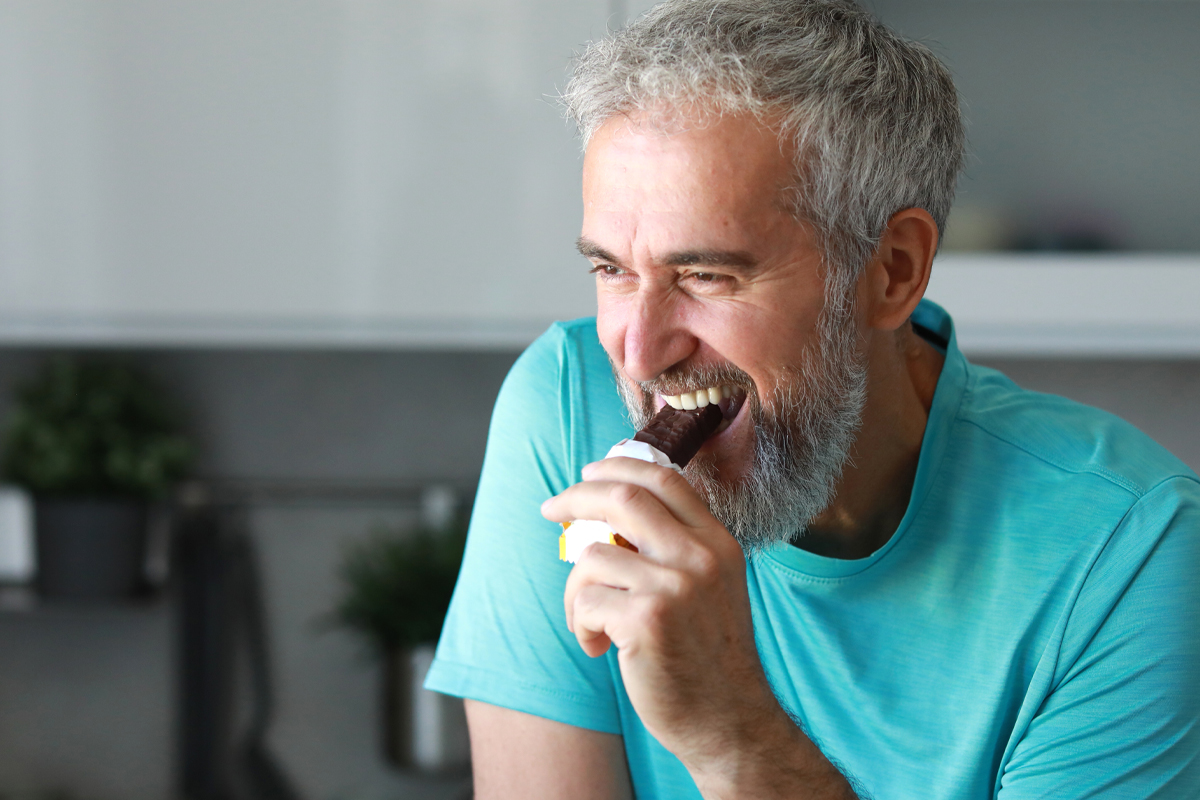 man enjoying a protein bar