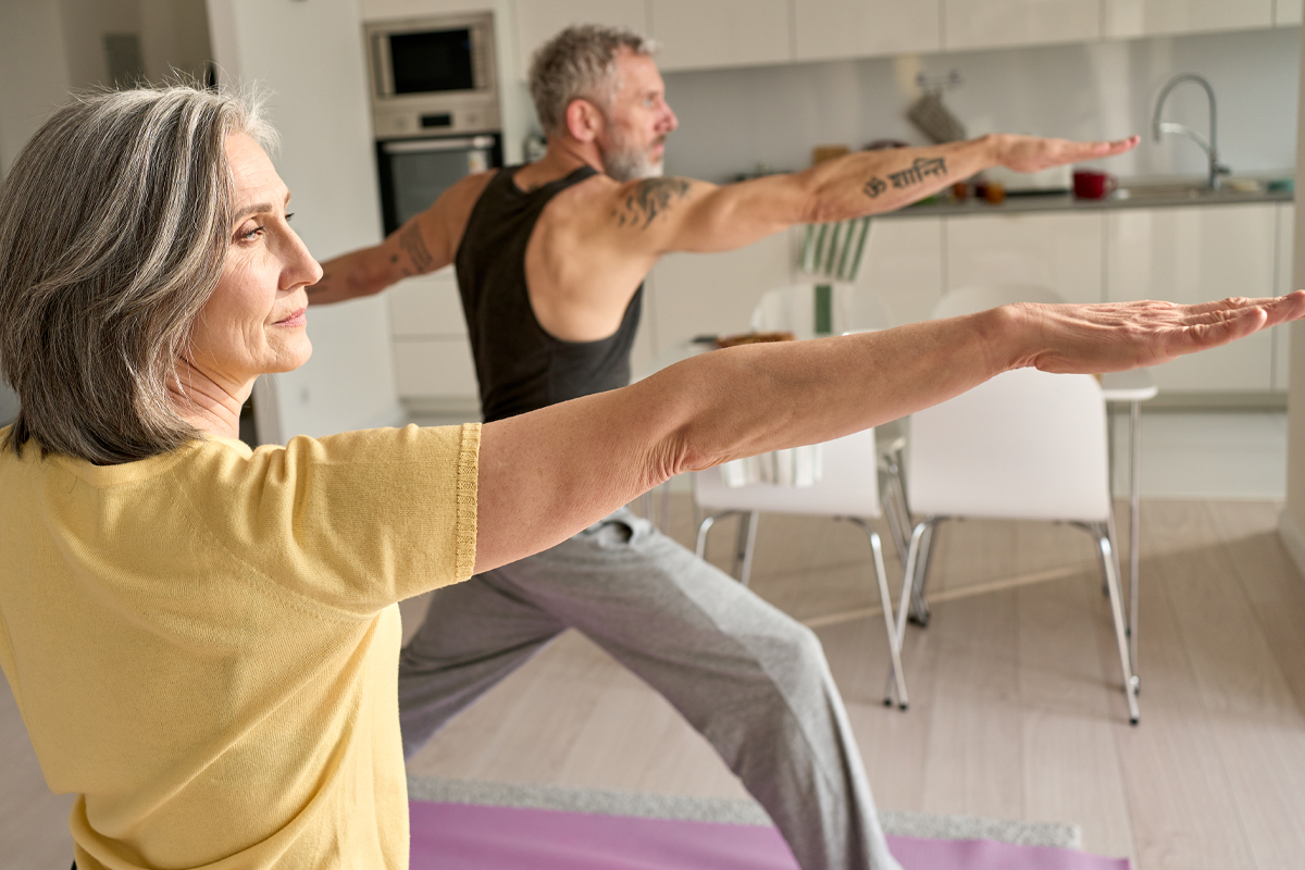 couple practicing yoga at home