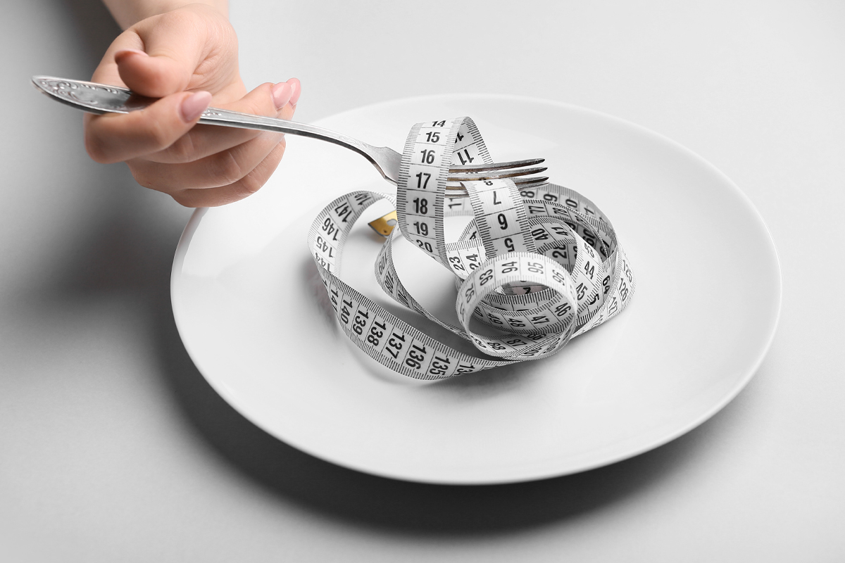 eating disorder disordered eating empty plate with fork and measuring tape