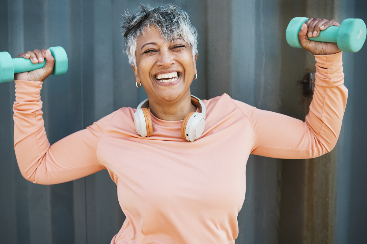 weight bearing exercise concept - mature woman with free weights