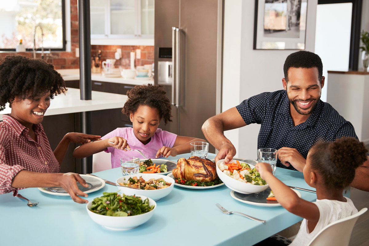 young family eating at the dinner table - mindful eating concept