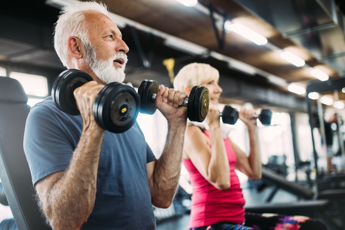 athletic senior couple weight training